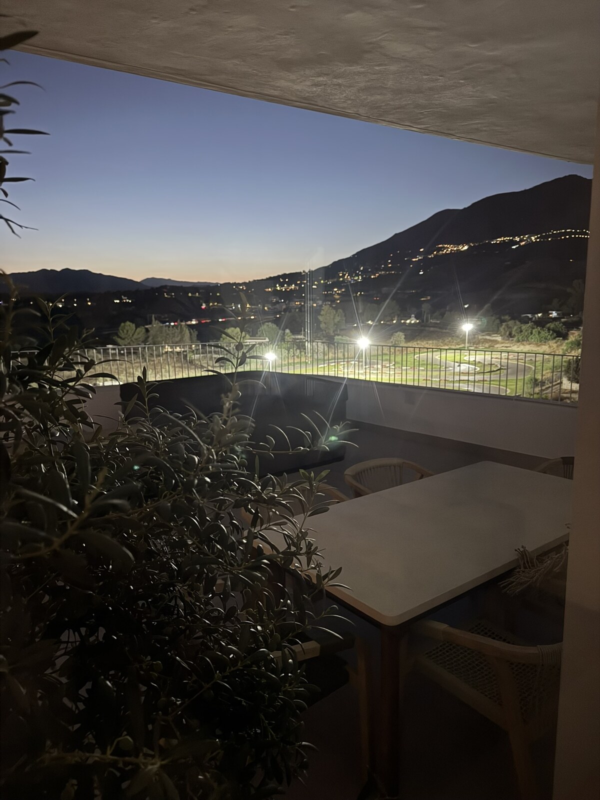 Kart-track spotlights shining towards occupied flats at Sunset Views